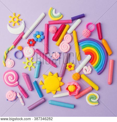 Abstract Purple Pastel Background With Many Kids Accessories From Clay, Wax Chalk, Concept Of Pop Ar