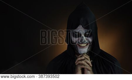 Creepy, Crazy Man With Skeleton Makeup In Hood. Guy Executioner Making Angry Faces, Shaking Head, Tr