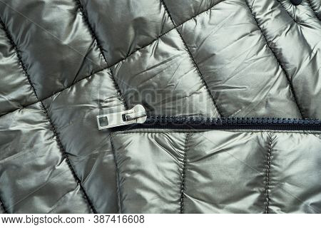 Close-up Zipper Closure On A Light Warm Olive-colored Jacket. Warm Clothes, Accessories For Outerwea