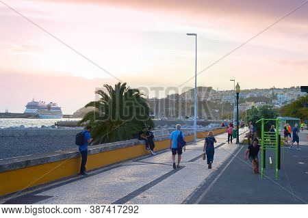 Funchal, Madeira Island, Portugal - Feb 04, 2020: People Walking By Embankment Of Funchal. Funchal I