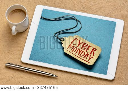 Cyber Monday sign - a paper price tag displayed on screen of a digital tablet, online hoilday shopping concept