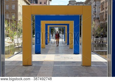 Laspezia, Italy - Summer 2020: A Man Walks Down A Colorful Hallway In A City Park. High Quality Phot