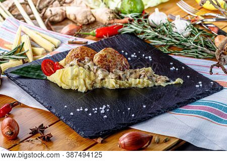 Mashed Potatoes With Cream Mushroom Sauce And Chopped Cutlet Are On The Plate