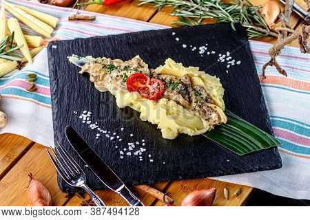 Mashed Potatoes With Cream Mushroom Sauce And Chopped Cutlet Are On The Plate