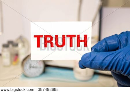 The Word Truth Appearing Behind Torn Brown Paper.