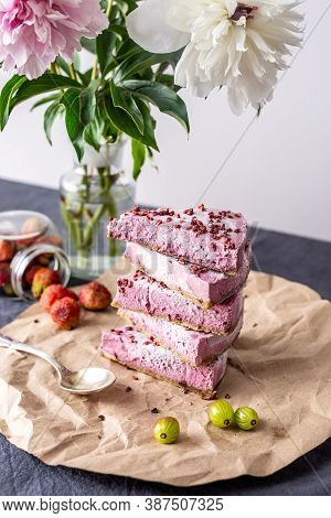 Pink Pieces Of Mousse Raw Cake Are Arranged In The Form Of A Pramida One On Top Of The Other. Next T