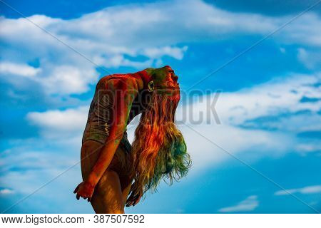 Beautiful Young Woman With Amazing Body-art Color. Color Womans Body With Colorful Holi Splash. Abst