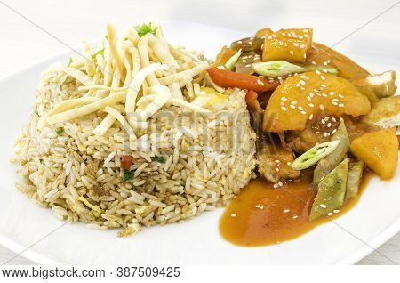 Chinese And Peruvian Fusion Food: Chicken With Peach And Chaufa Rice Called Tipakay