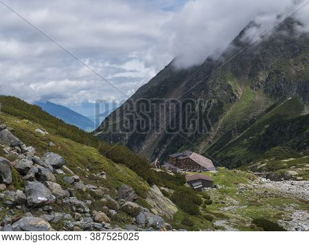Summer View Of Sulzenau Mountain Hut, Sulzenauhutte With Resting Tourist People. Alpine In Mountain 
