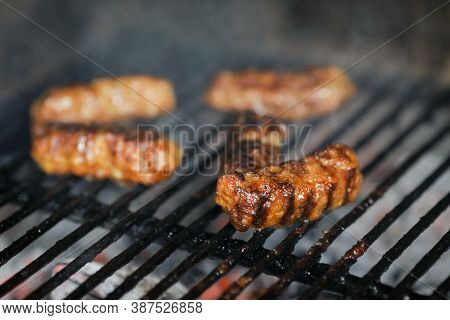 Shallow Depth Of Field (selective Focus) Image With Romanian Traditional Mici (mititei), Grilled Gro
