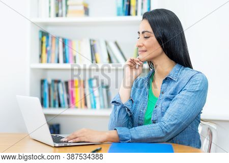 Mexican Mature Adult Woman Straming And Watching Movie Online At Computer Indoors At Home
