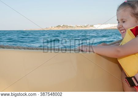 Little Girl Sails By Boat By Sea On A Clear Day