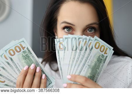 Young Businesswoman Is Holding Many American Dollars In Her Hands, Covering Her Face. Disbursement O