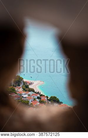 Vertical Shot Of A Beach In The City Of Omis, Croatia As Seen From The Mountain Top, Framed Between 