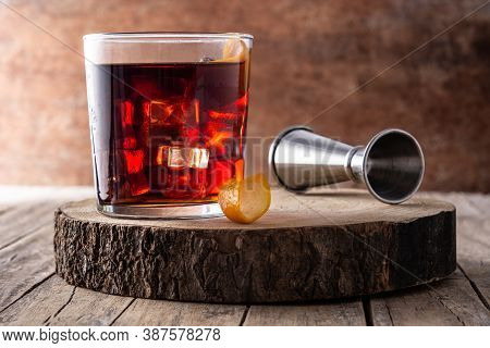 Boulevardier Cocktail And Orange Zest On Rusty Background.