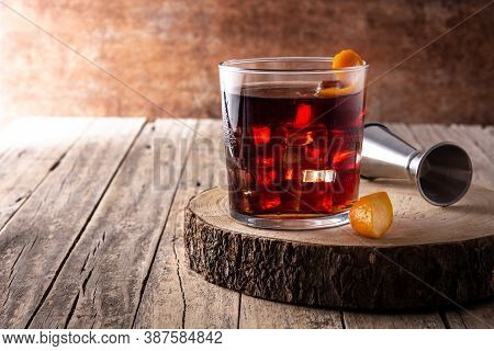 Boulevardier Cocktail And Orange Zest On Rusty Background. Copy Space