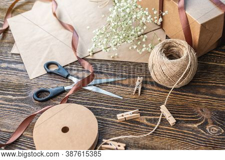 Craft Paper And Tools For Creating And Decorating Gift Packaging. There Is Cardboard, Brown Ribbons 