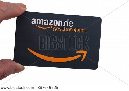 Wetzlar; Germany 2020-09-15, Finger Holding German Amazon Voucher Card Against White Background. Ama