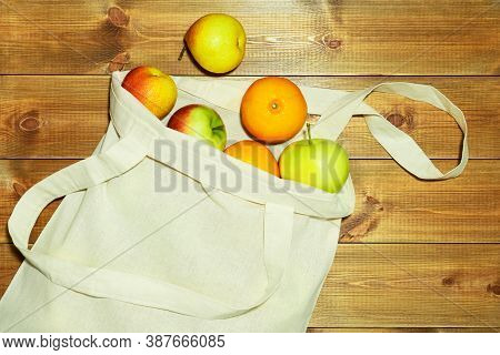 Eco Frienfly Natural Bag With Products On Natural Wood Background. Environment Protection And Zero W