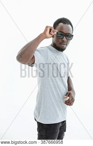 Handsome Guy Looking Intently Through Sunglasses . Isolated On White
