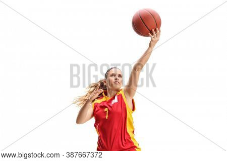 Female basketball player doing layup isolated on white background