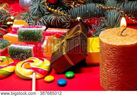 Leneds On A Stick And Marmalade On A Red Background With A Burning Candle. Banner For Confectionery 