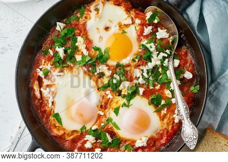 Shakshouka, Eggs Poached In Sauce Of Tomatoes, Olive Oil. Mediterranean Cousine.