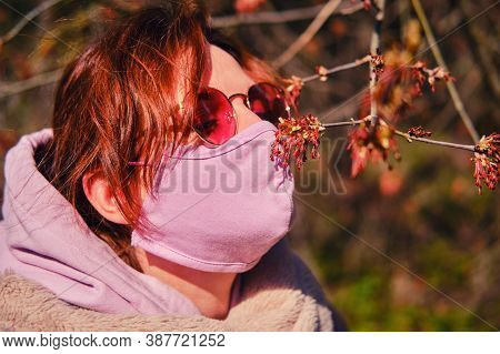 Woman In Medical Mask In Spring Forest After Quarantine Due To Coronavirus Epidemic. Concept Of Reco