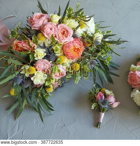 Bridal Bouquet And Boutonniere Are On The Table. The Bunch Consists Of Roses, Craspedia, Dianthus, E