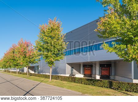 Large Warehouse With Loading Docks With Some Nice Trees In Front