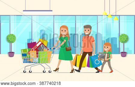 Family Does Lot Of Buying In Hypermarket. Mom Rolls Large Shopping Cart. Dad Carries Lot Of Paper Ba