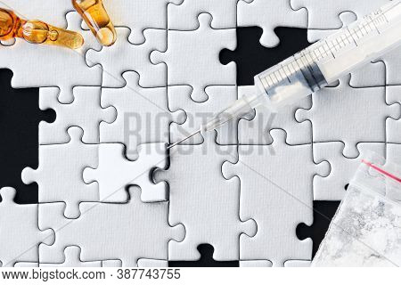 Syringe Of Heroin, Glass Ampoules, Package Of Cocaine Powder Are Scattered On Background. White Gray