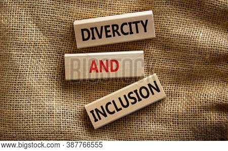 Wooden Blocks Form The Text 'divercity And Inclusion' On Beautiful Canvas Background. Concept.