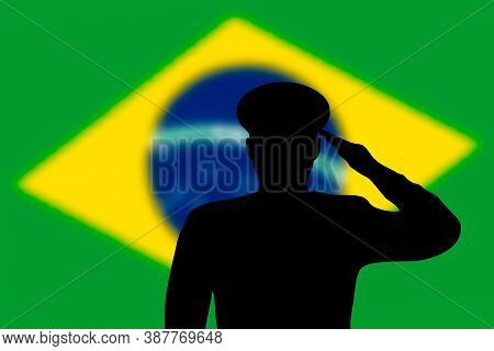 Solder Silhouette On Blur Background With Brazil Flag.