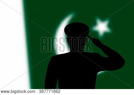 Solder Silhouette On Blur Background With Pakistan Flag.