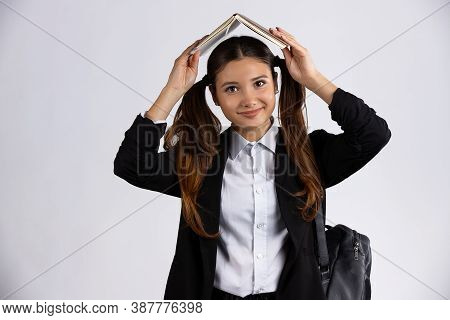Photo Portrait Of Brunette Girl Holding Open Book Over Head Isolated On White Background