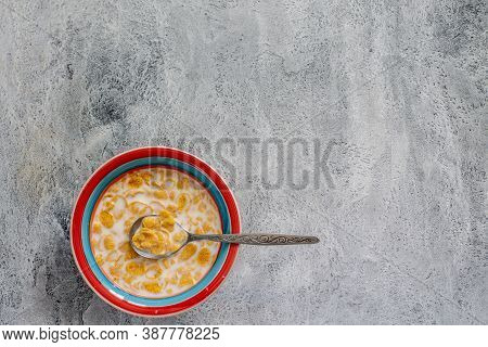 Cornflakes With Milk In A Colorful Plate