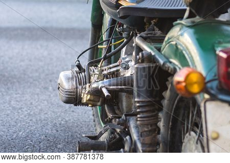 Left Side Of The Old And Rusty Green Motorcycle With An Opposed Engine. Closeup. Selective Focus
