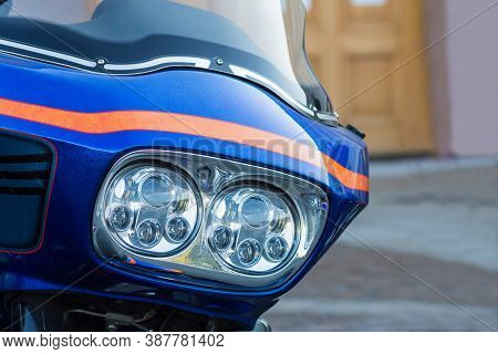 Closeup Photo Of Blue Modern Motorcycle With Stylish Batwing And Custom Headlights. Motorcycle Is Pa