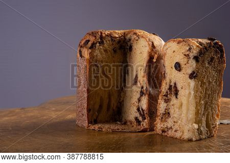Panettone With Chocolate Chips On Rustic Wood With Gray Background, Selective Focus.