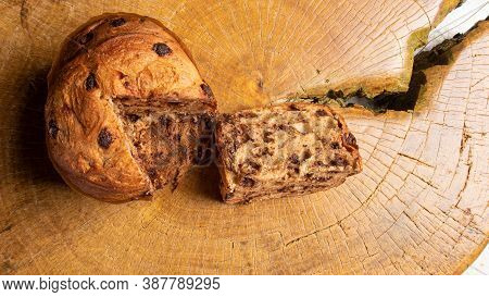 Panettone With Chocolate Chips On Rustic Wood, Top View