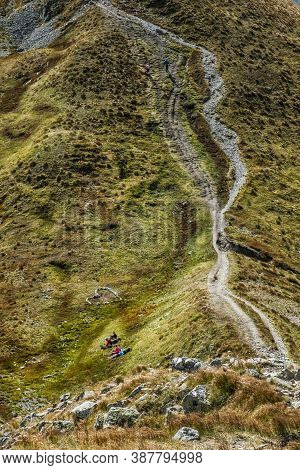 Resting Tourists And Stoned Heart Western Tatras Mountains, Slovak Republic. Hiking Theme. Seasonal 