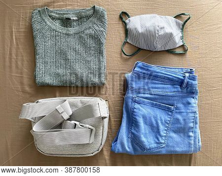 Matching Reusable Face Mask With Outfit. Green Sweater, Matching Cotton Face Mask, Blue Jeans And Gr