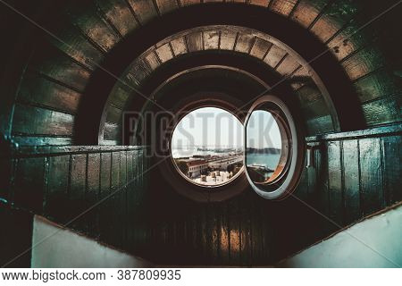 A Wide-angle View Of A Wooden Arc In A Nook Recess Of A House With A Round Opened Window Or A Portho