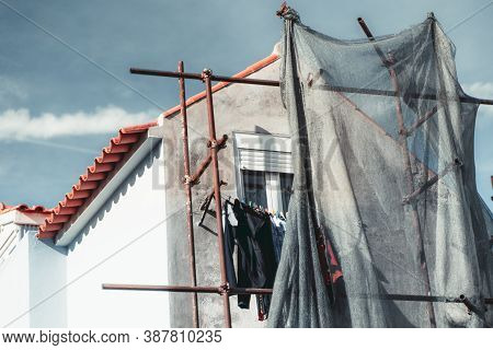 An Elevation Of A Typical White European House Under Construction On A Sunny Day With Scaffolds And 