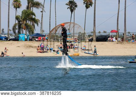 Man Flying Flyboarding On A Flyboard - Hydroflighting Device Which Supplies Propulsion To Drive The 