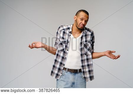 I Dont Know Gesture - Young Afrcian American Man Over Grey Background Being At A Loss, Showing Helpl