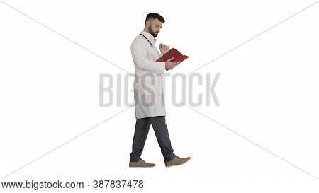 Doctor Reading A Book Or A Journal While Walking On White Backgr