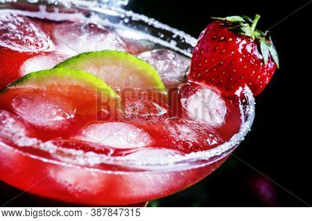 Alcoholic Cocktail With Strawberry, Lime And Ice In The Glass, Decorated With Sugar, Black Backgroun