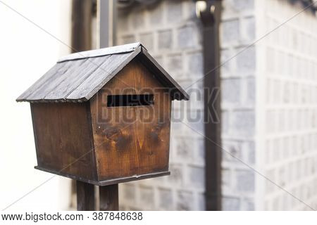 Old Wooden Mailbox, House Shape Placed On White Wall.